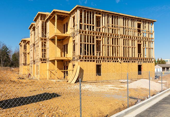 a temporary chain link fence winding around a job site, outlining the project's progress in South San Francisco, CA